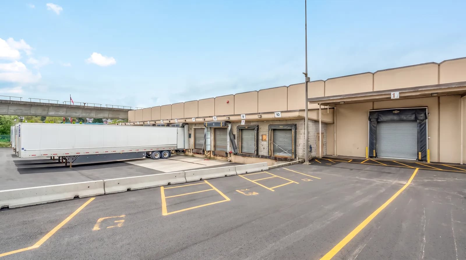 The truck court at the Vancouver warehouse: numbered dock doors and a trailer at the wall